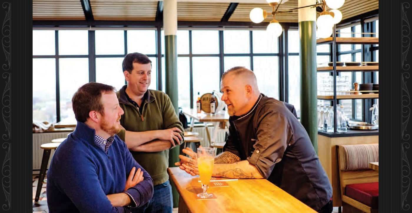 Old Line founders Mark McLaughlin, left and Arch Watkins chat with Wilbur Cox, executive chef, in the Hotel Revival's restaurant, Topside.